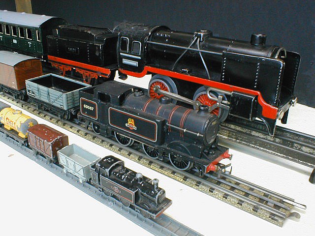 Examples of early model trains in O gauge (rear), OO gauge (middle 