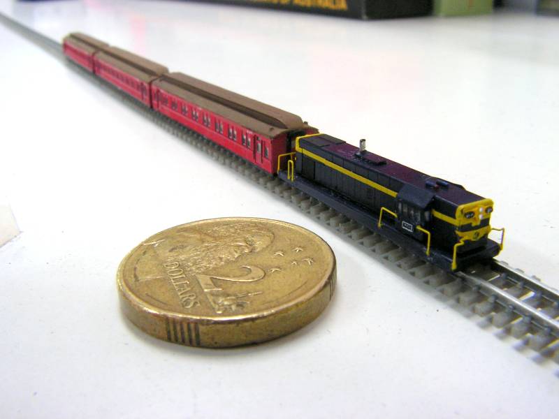gauge trains on double track with $1 coin; front views; catenary 